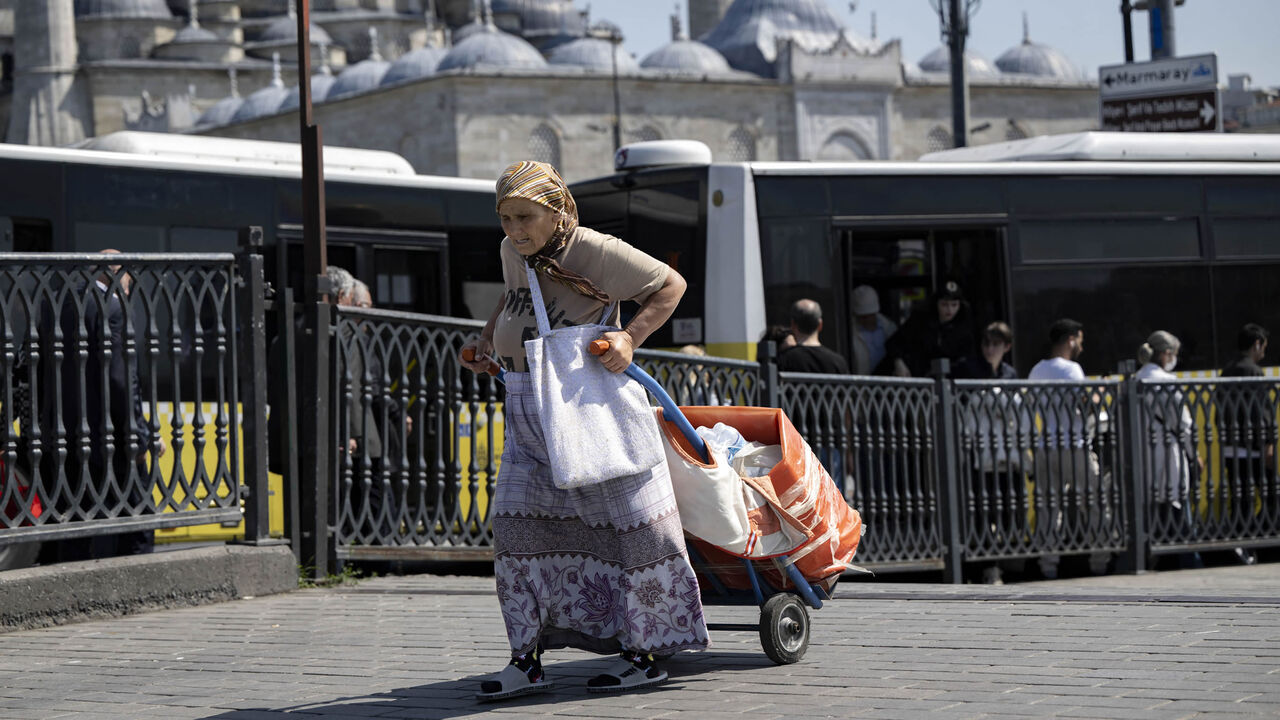 An elderly woman pulls a trolley ahead of the May 28 Turkey's presidential run-off, Istanbul, Turkey, May 22, 2023.